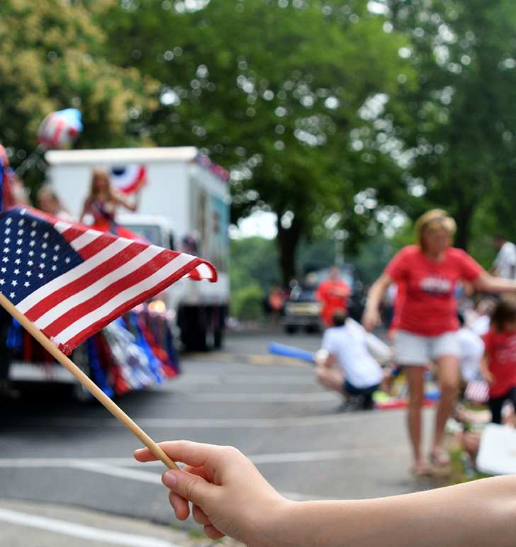 Waving an American flag at the Independence Day Parade on the 4t